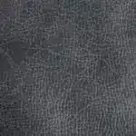 A close-up of a dark gray leathery texture reminiscent of the durable upholstery on a PR448 Titan Lift Recliner, showcasing fine, irregular cracks and lines that create a rugged pattern.