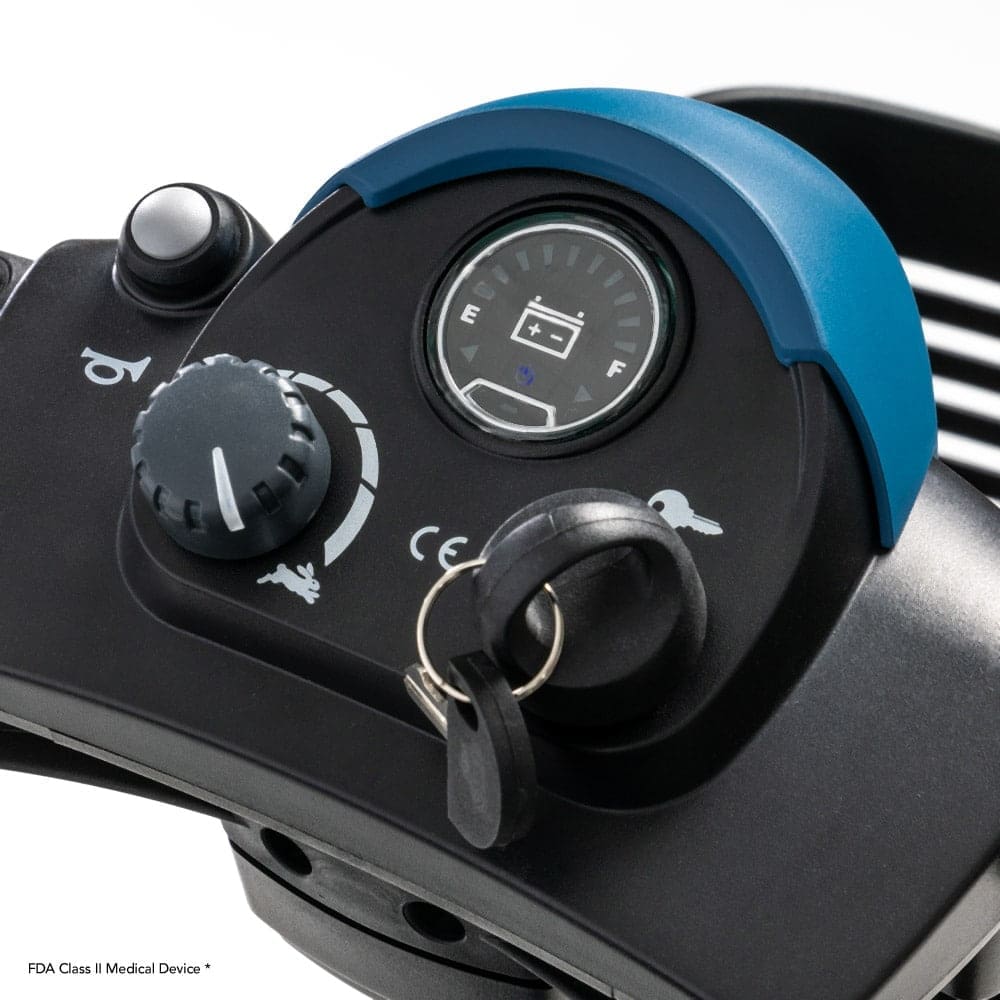 Close-up of the GoGo Elite Traveller 2 by Pride mobility scooters dashboard featuring a key ignition, battery level indicator, speed control knob, and ergonomic handle with a blue accent detail.