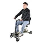 A person in a black jacket and jeans smiles while sitting on a SuperHandy Passport Pro Scooter. Against a plain white background, this three-wheeled mobility scooter showcases a comfy seat, handlebars, and an efficient battery pack.