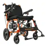 The SuperHandy Cares Portable Power Chair features a foldable electric design with an orange and black frame, padded armrests, left-side control joystick, and sturdy wheels. SUPERHANDY is prominently displayed on the footrest.