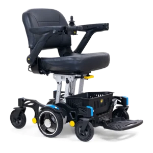 The Buzzaround Carry On Powerchair is a black electric wheelchair with a padded seat, armrests, joystick controls, and sturdy wheels. It features a small storage basket underneath and a foldable footrest for easy transport.
