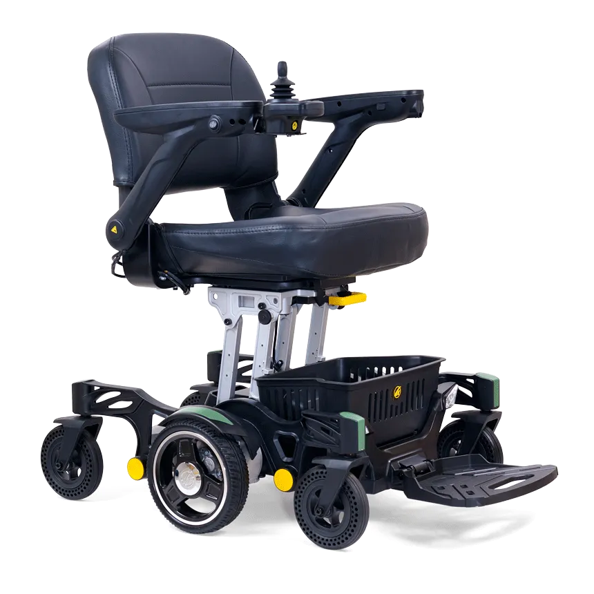 The Buzzaround Carry On Powerchair is a stylish black and grey electric wheelchair with a cushioned seat, armrests, right-hand joystick control, four wheels, footrests, and a handy basket underneath for comfort and functionality.
