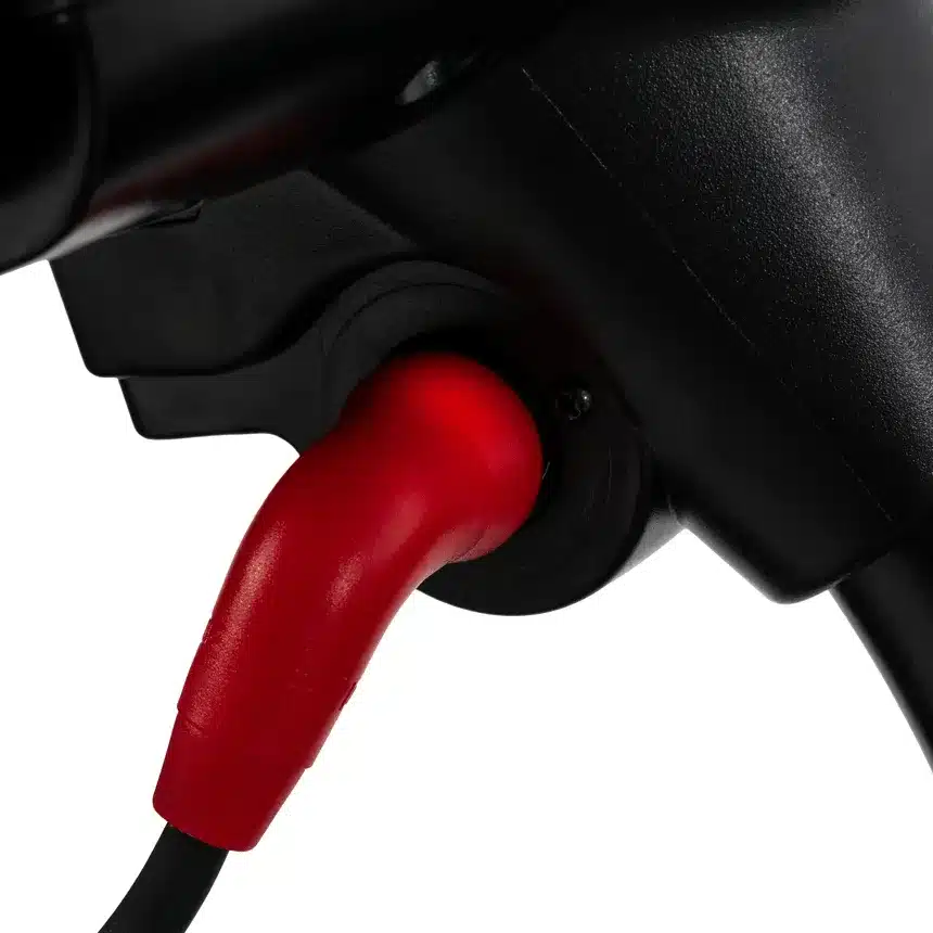 A red charging cable plugged into the power port of a Go Go Elite Traveller 2 Platinum.
