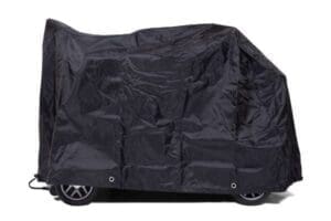 A black GOLDEN TECHNOLOGIES SCOOTER COVER draped over a mobility scooter.