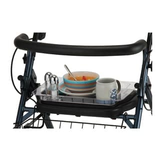 The Nova Star 8 DX Wide Rollator, equipped with a convenient tray attachment, elegantly supports a bowl of fruit, a spoon, a mug, and salt and pepper shakers.
